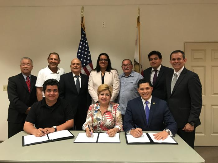MBDA Acting National Director Chris Garcia, MBDA staff and members of the Orange Line Development Authority Eco-Rapid Transit gathered to sign a Memorandum of Understanding (MOU) during a special signing ceremony in South Gate, California on June 29. 