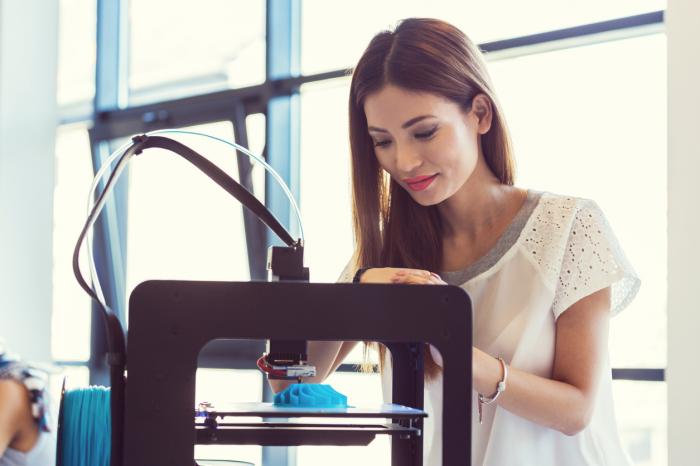 young woman using 3D printer 