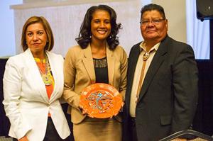 Monica Jojola, Principal of Montech, Inc., and Ted Pedro, Director, Santa Fe MBDA Business Center, present a memorial placard to Candace Shiver, Special Advisor to the MBDA National Director, during the 2014 8th Annual New Mexico Native American Economic 